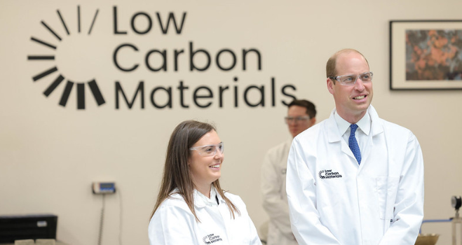 Natasha Boulding and Prince William in front of Low Carbon Materials logo