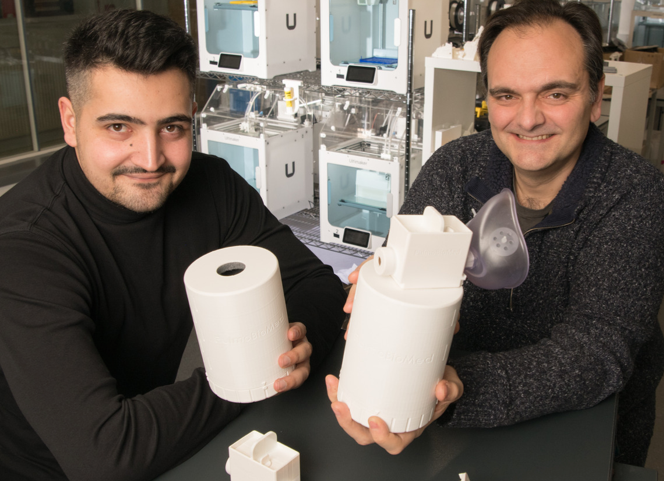 Founders of pulmobiomed holding a breath sampling device
